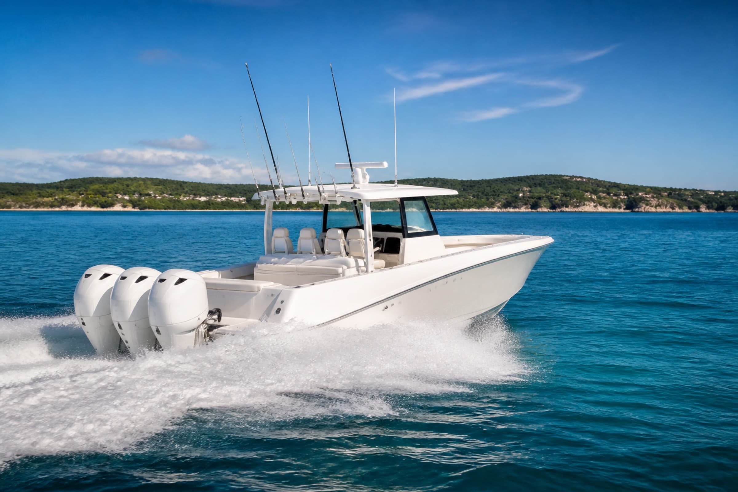 A white center-console boat with triple outboards moving left to right across open water.